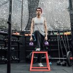 Adult male performing kettlebell exercises in a modern Mexico City gym.